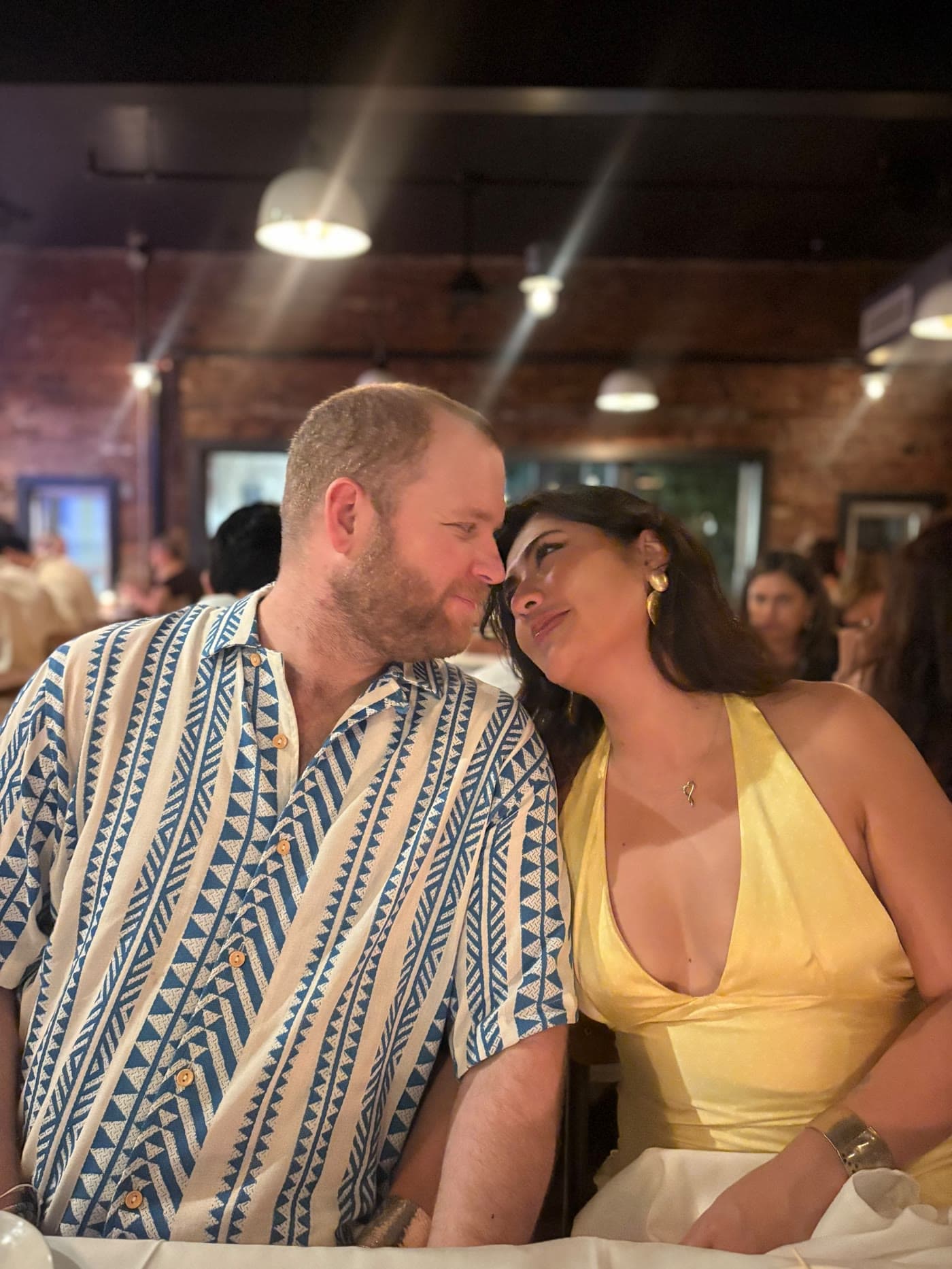 Brenden and Nicole look at each other during dinner